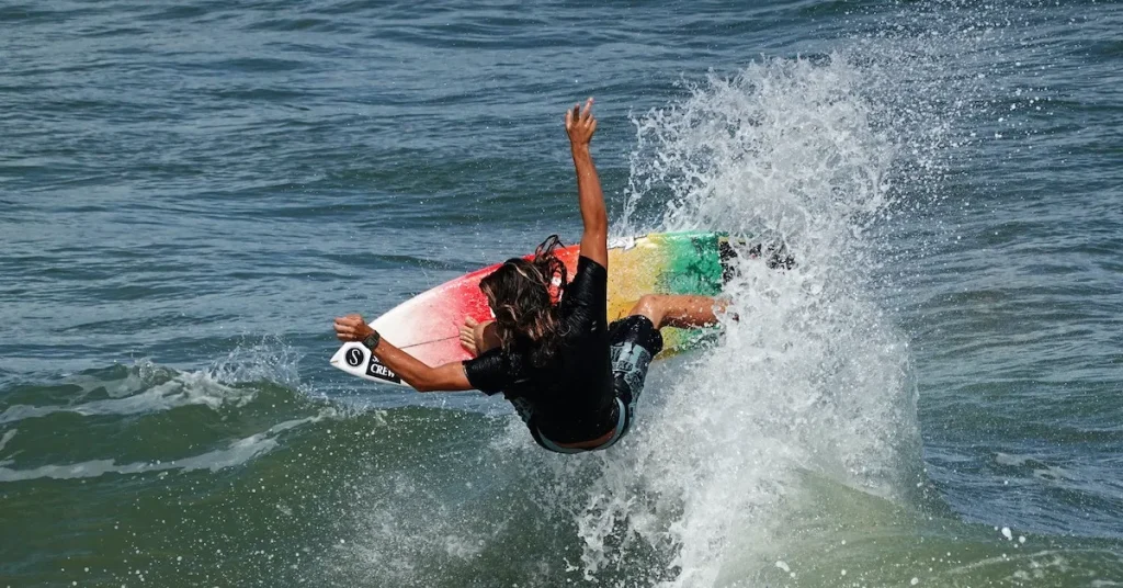 Florida surfer riding a wave and doing a trick on his surf board in Flagler Beach